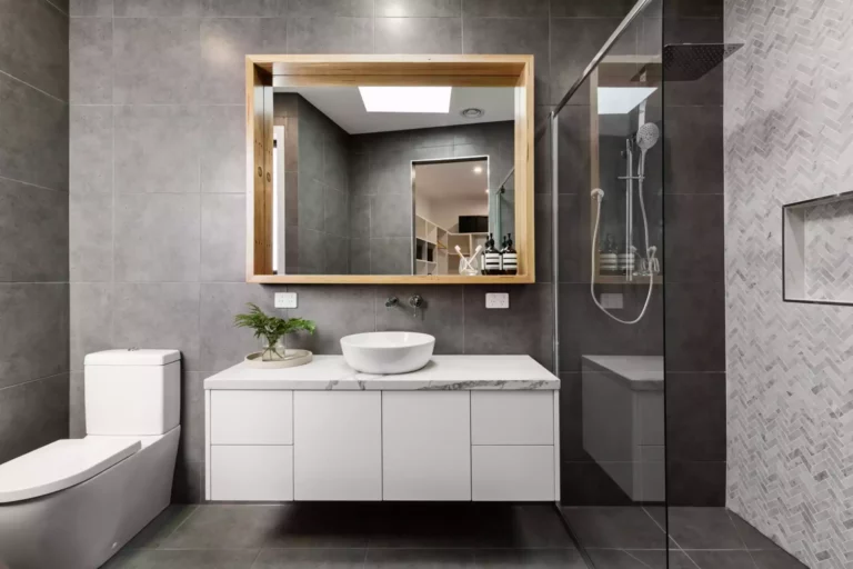 A bathroom with a white vanity in the center.