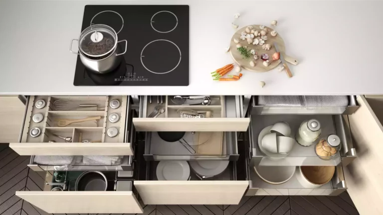 An overview of a kitchen stovetop and counter, with several drawers pulled out showing storage options.