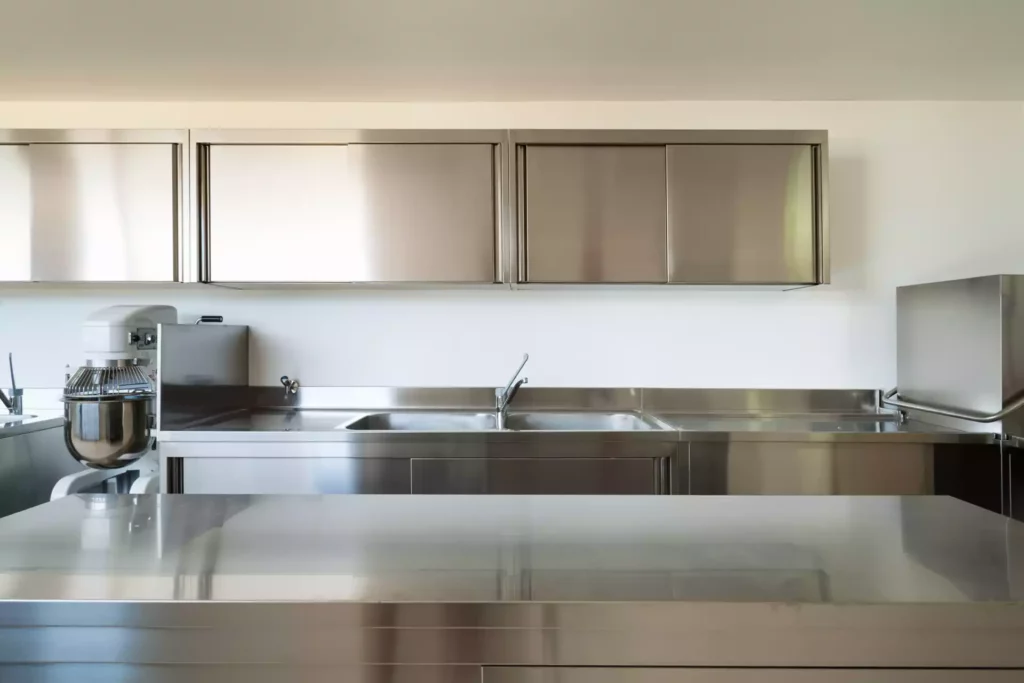 A kitchen with shiny metal cabinets.