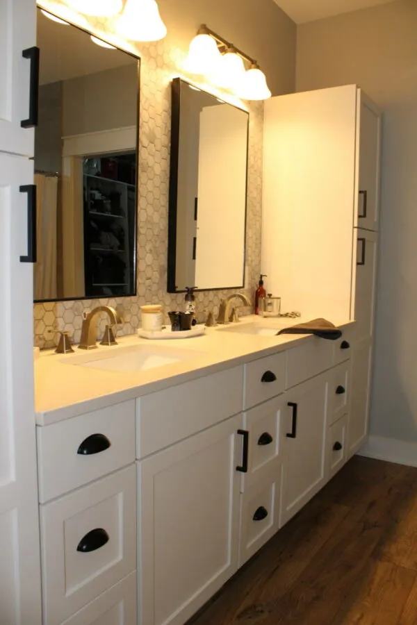 Master bath with painted cabinets, quartz countertops and his/hers sinks and linen cabinets in Greenville